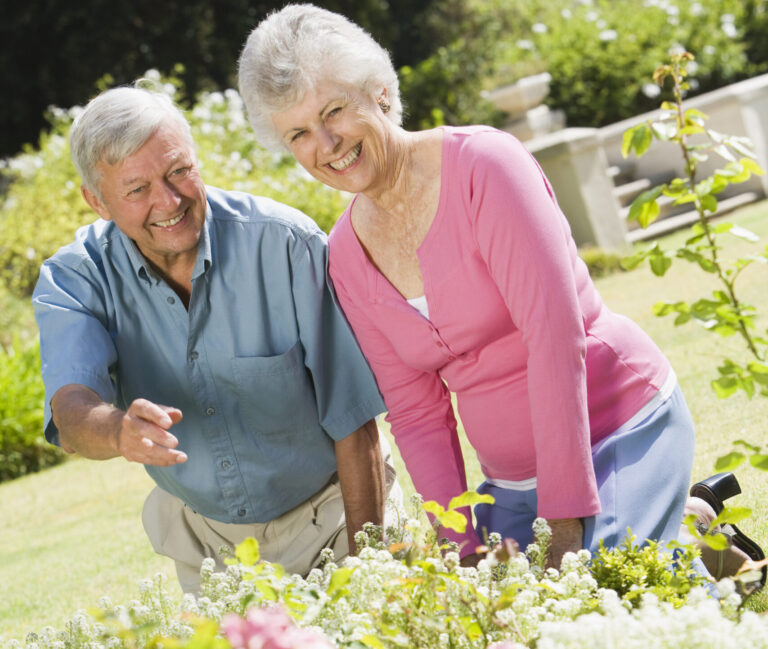 Senior,Couple,Working,In,Garden