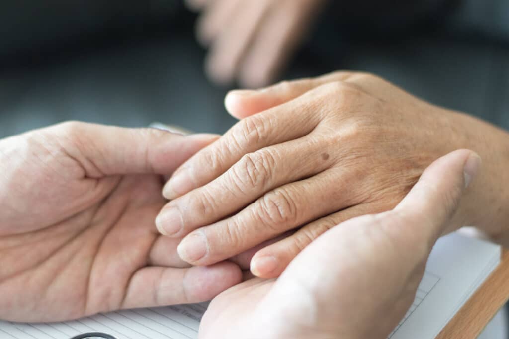 Caregiver Holding Older Woman's Hand