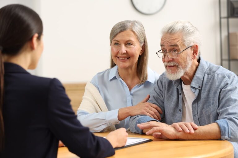 Couple of seniors talking to a woman.