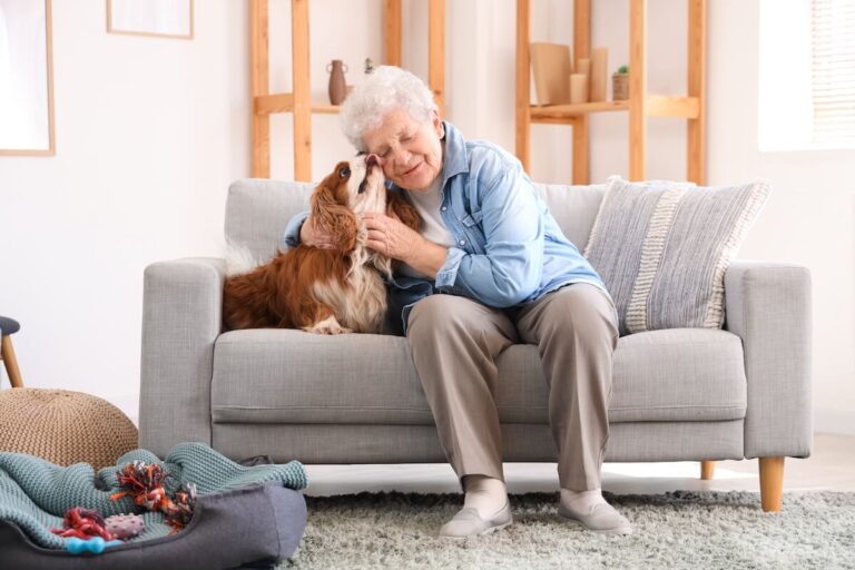 Older woman petting her little dog