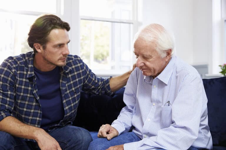 Adult man talking to his senior father