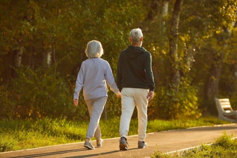 A couple of seniors walking together and holding hands