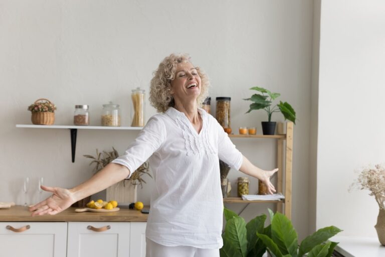 Joyful older woman spreading her arms